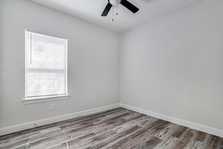 Bedroom 3 with hardwood / wood-style flooring and ceiling fan