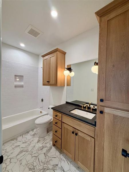 Bathroom with vanity, shower / washtub combination, and recessed lighting