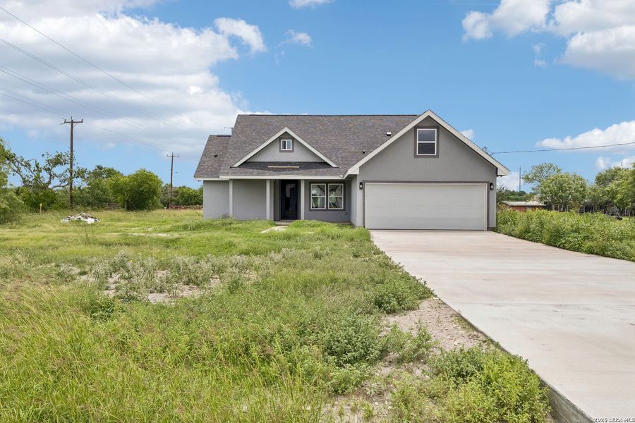 Front exterior of a new home in , Natalia, TX, highlighting curb appeal (Image 25).