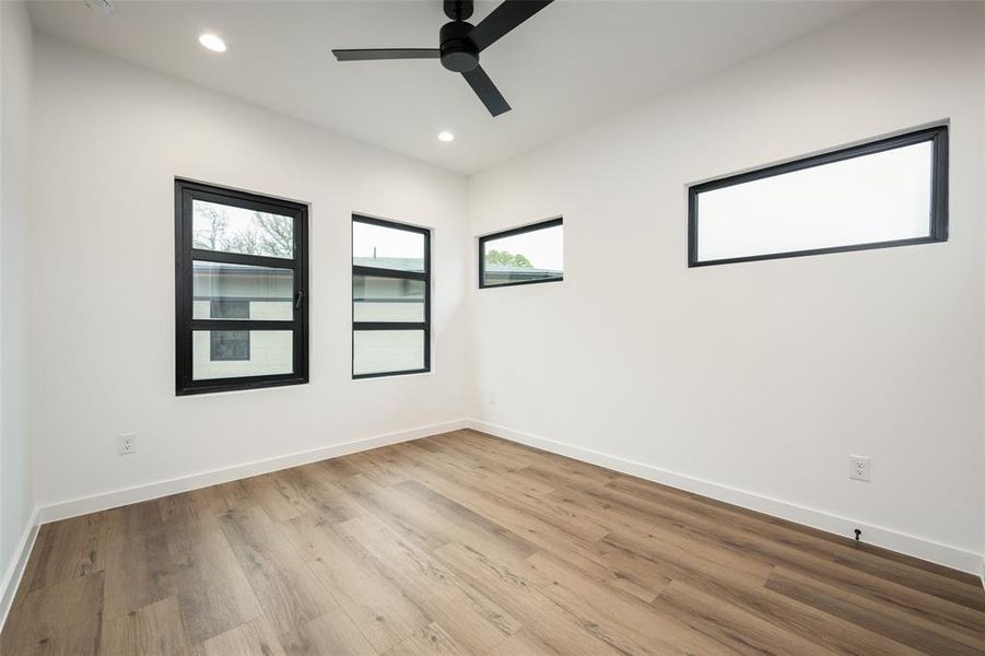 Empty room with ceiling fan, wood finished floors, and recessed lighting Empty room with ceiling fan, wood finished floors, and recessed lighting