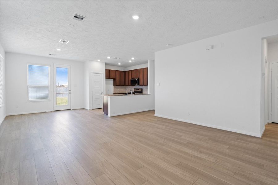 Beautiful open-concept layout effortlessly uniting the living, dining, and kitchen spaces—ideal for everyday comfort and entertaining guests!