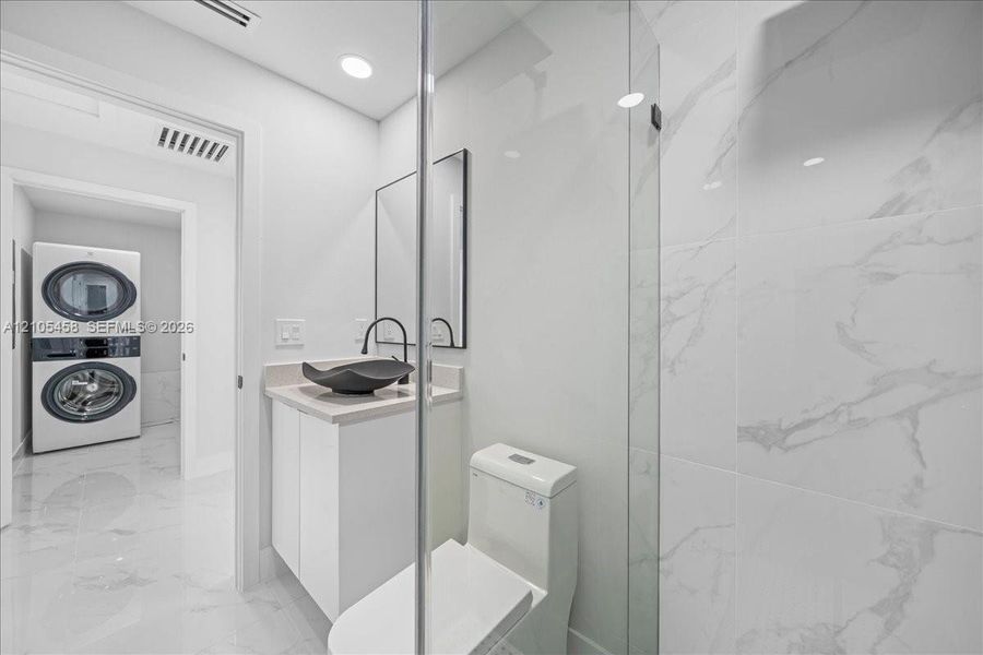 Modern vanity with a vessel sink, single-handle faucet, and built-in cabinetry Modern vanity with a vessel sink, single-handle faucet, and built-in cabinetry