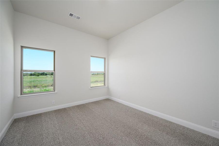 Carpeted spare room with a healthy amount of sunlight