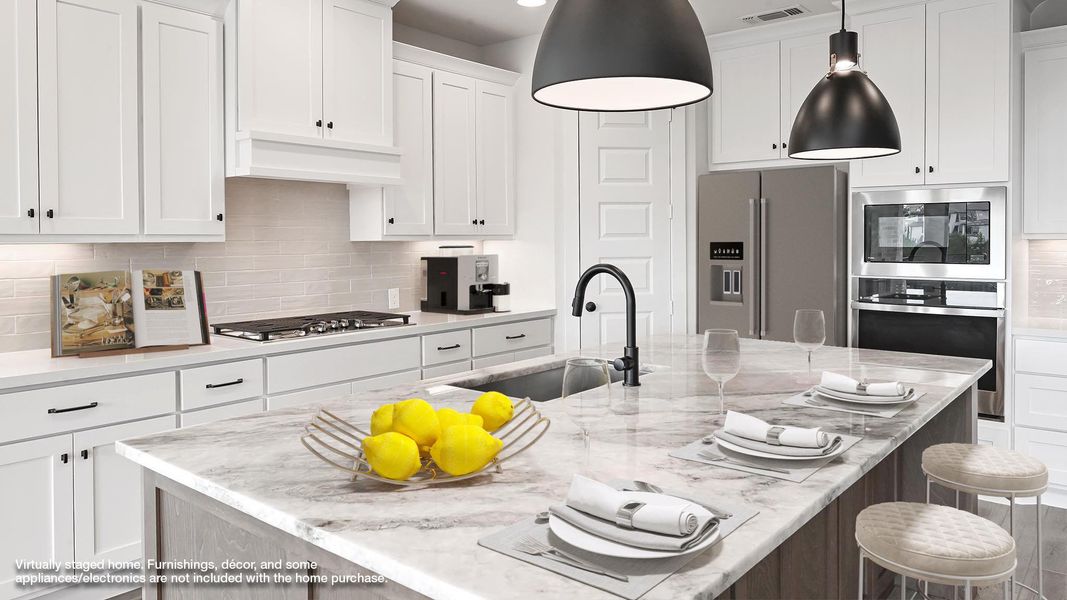 Kitchen featuring appliances with stainless steel finishes, white cabinetry, a breakfast bar area, hanging light fixtures, and tasteful backsplash Kitchen featuring appliances with stainless steel finishes, white cabinetry, a breakfast bar area, hanging light fixtures, and tasteful backsplash