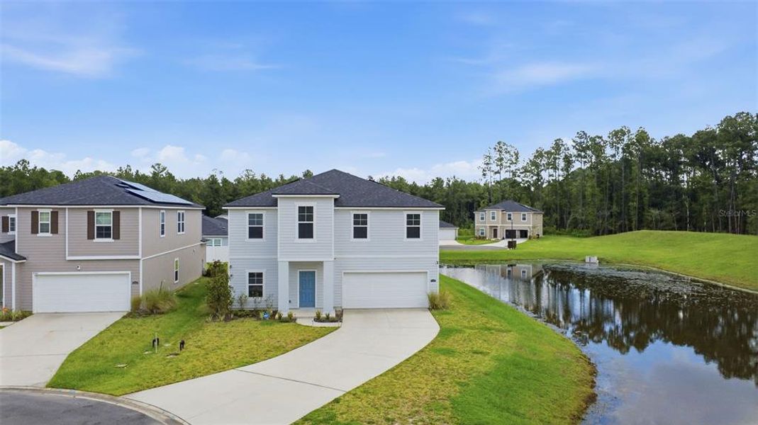 Front exterior of a new home in Dunns Crossing, Jacksonville, FL, highlighting curb appeal (Image 2). Front exterior of a new home in Dunns Crossing, Jacksonville, FL, highlighting curb appeal (Image 2).