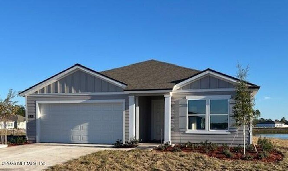 Front exterior of a new home in Sawmill Branch, Palm Coast, FL, highlighting curb appeal (Image 1). Front exterior of a new home in Sawmill Branch, Palm Coast, FL, highlighting curb appeal (Image 1).