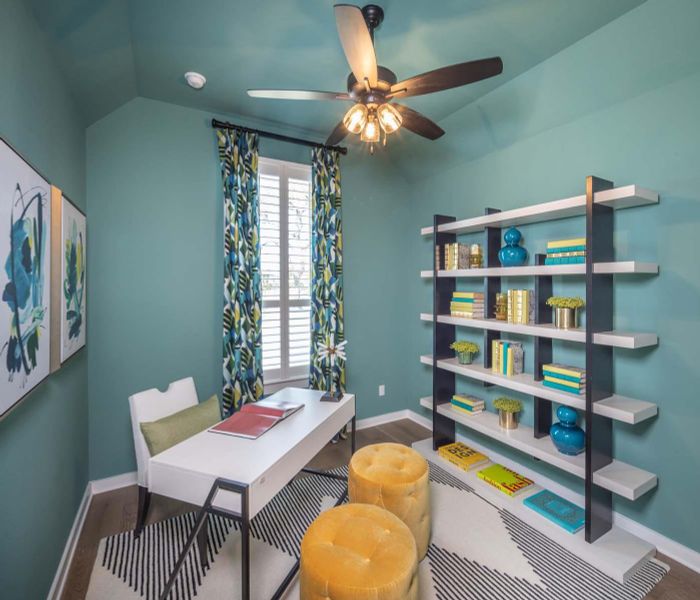 Home office with baseboards, lofted ceiling, and wood finished floors