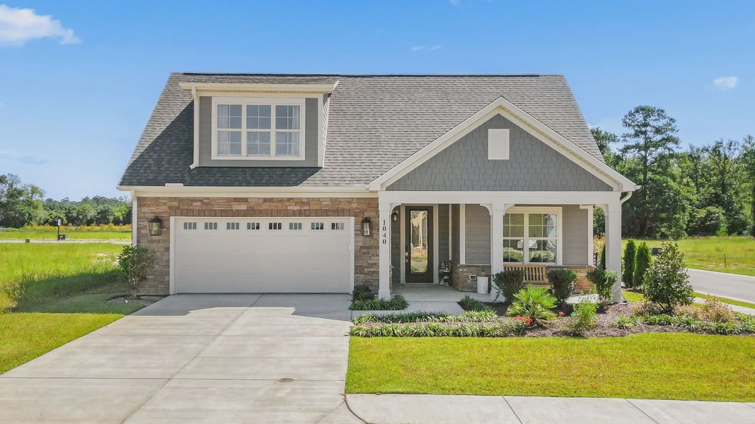 Front exterior of a new home in Courtyards by Carrell, Ocean Isle Beach, NC, highlighting curb appeal (Image 1). Front exterior of a new home in Courtyards by Carrell, Ocean Isle Beach, NC, highlighting curb appeal (Image 1).