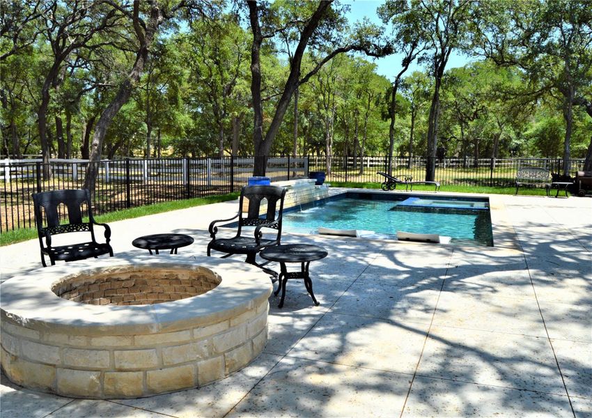 View of pool featuring a patio area and a fire pit View of pool featuring a patio area and a fire pit