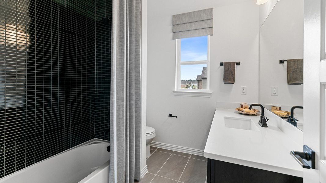 Representative furnished interior of a home built from the Magnolia by Brightland Homes in Sunterra, Katy (Image 22).