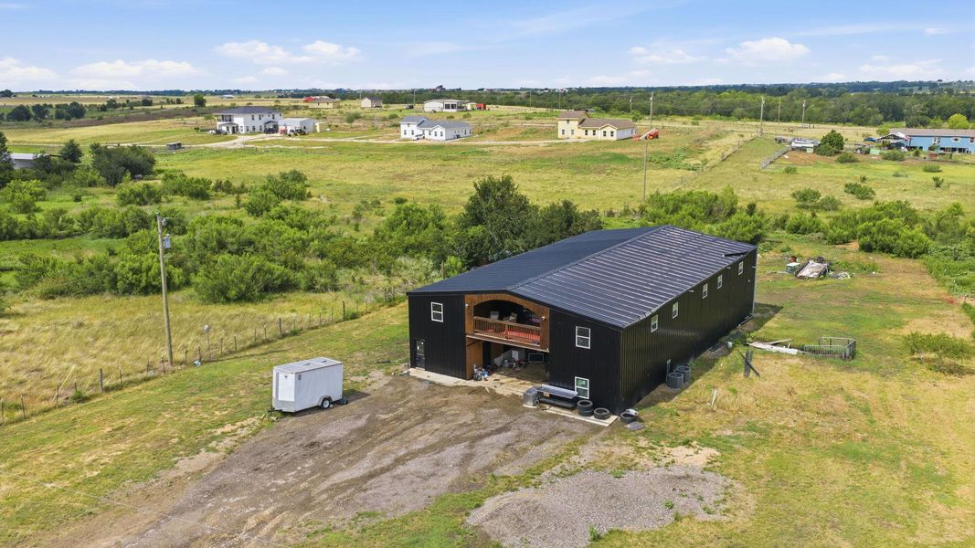 Perched on a verdant lot, this robust structure offers a secluded retreat with ample open space.