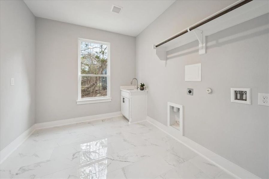 Laundry room featuring sink, hookup for an electric dryer, hookup for a washing machine, and gas dryer hookup