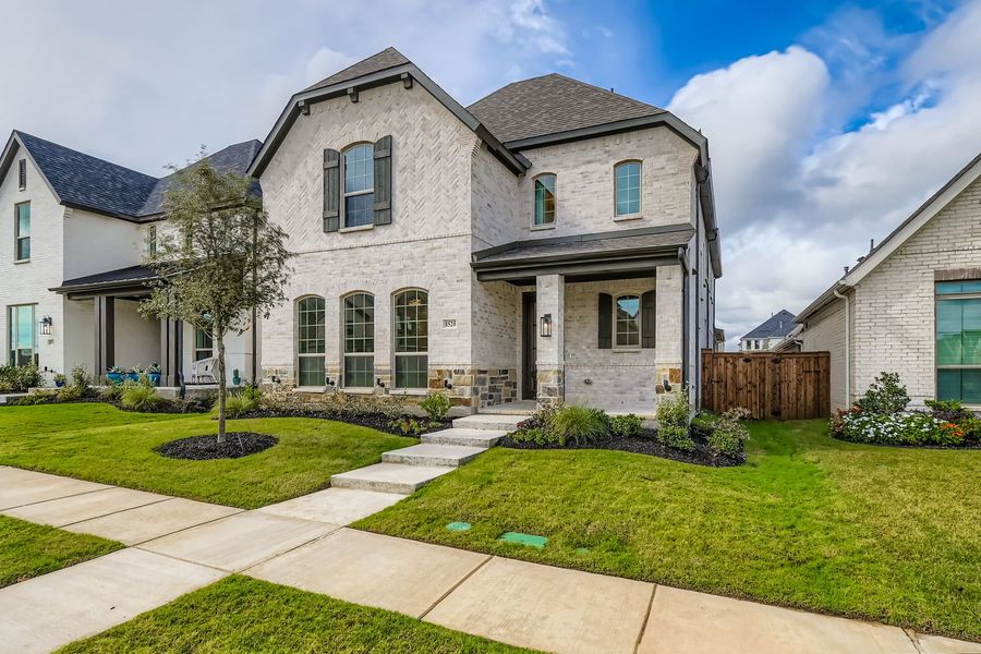 Front exterior of a new home in The Tribute - Westbury 41s, The Colony, TX, highlighting curb appeal (Image 2). Front exterior of a new home in The Tribute - Westbury 41s, The Colony, TX, highlighting curb appeal (Image 2).