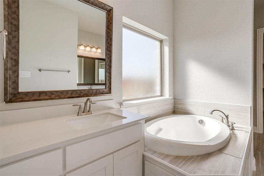 Bathroom with a bath and vanity