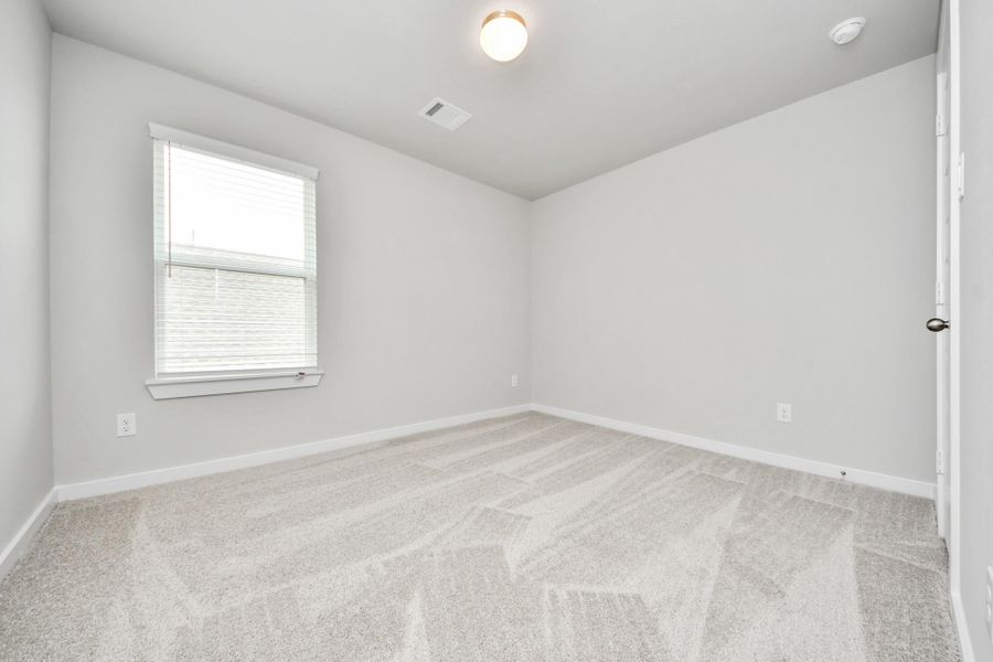 Generously sized secondary bedrooms featuring spacious closets, soft and inviting carpeting underfoot, large windows allowing plenty of natural light, and the added touch of privacy blinds for your personal retreat. Sample photo of completed home with similar floor plan. Actual colors and selections may vary.
