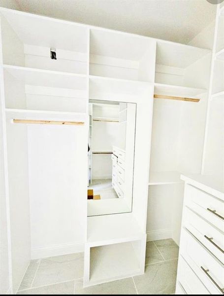 Walk in closet with light tile patterned flooring Walk in closet with light tile patterned flooring