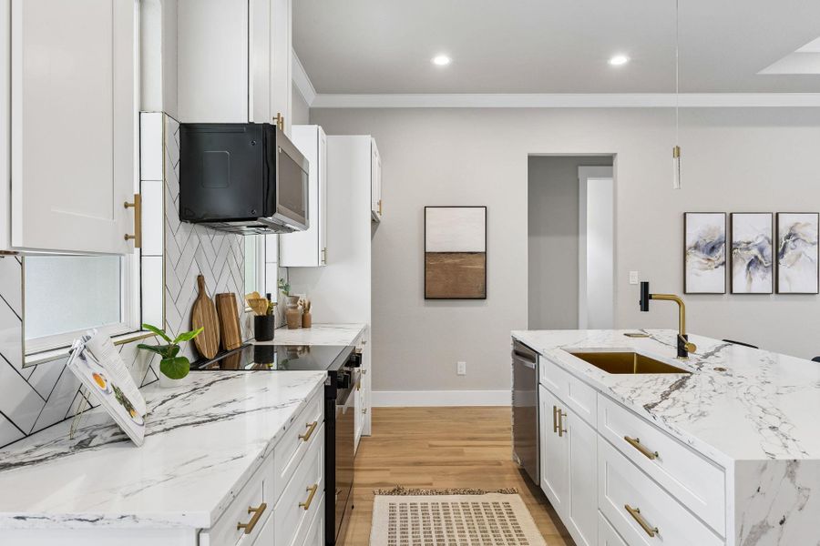 Gleaming marble counters and state-of-the-art appliances define this inviting, open-concept kitchen.