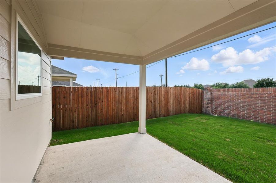 Fenced backyard featuring a patio