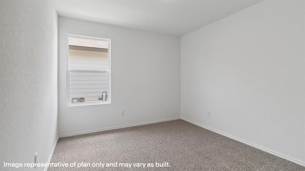 Carpeted empty room featuring baseboards