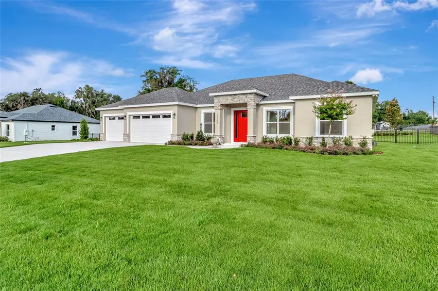 Front exterior of a new home in , Montverde, FL, highlighting curb appeal (Image 17). Front exterior of a new home in , Montverde, FL, highlighting curb appeal (Image 17).