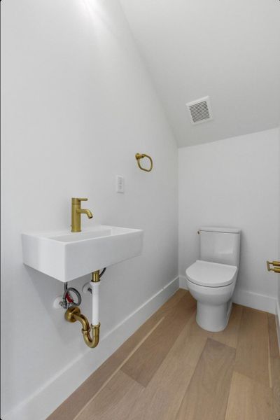 Bathroom with lofted ceiling and toilet Bathroom with lofted ceiling and toilet