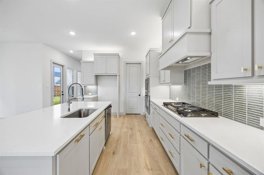 Beautiful cabinetry, gorgeous countertops and designer backsplash effortlessly pair with contemporary stainless steel to create a dream kitchen for the ages!