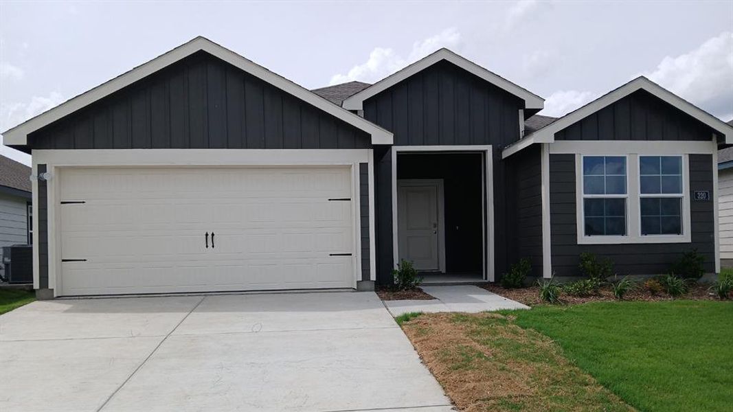 Contemporary single-story residence with dark vertical siding and white trim accents Contemporary single-story residence with dark vertical siding and white trim accents