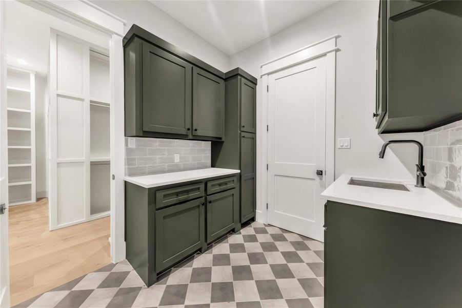 Laundry area with light flooring and a sink