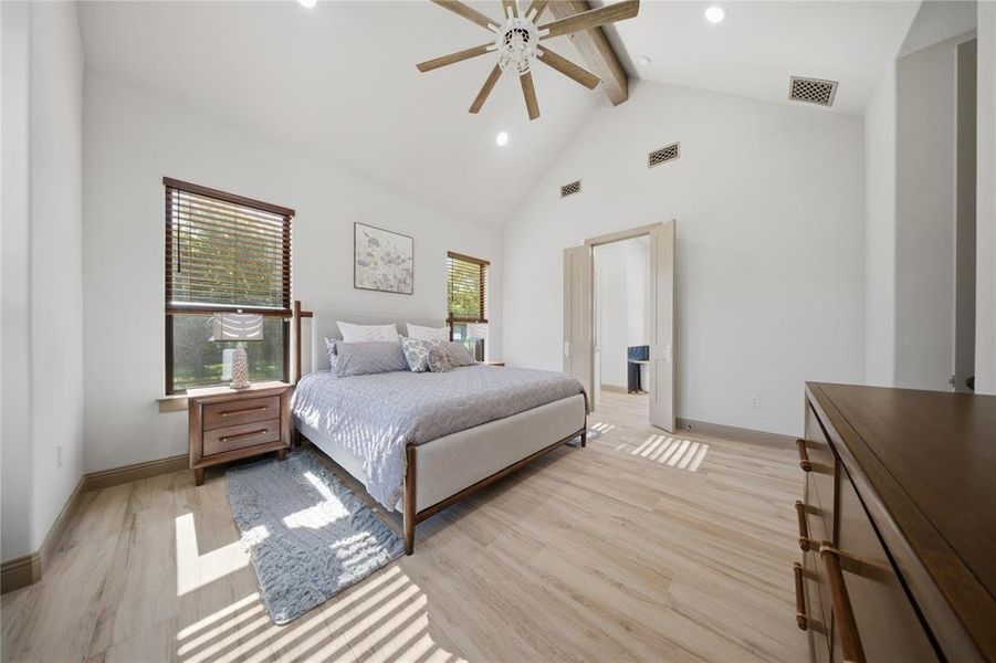 Vaulted ceiling with exposed wood beam and ceiling fan
