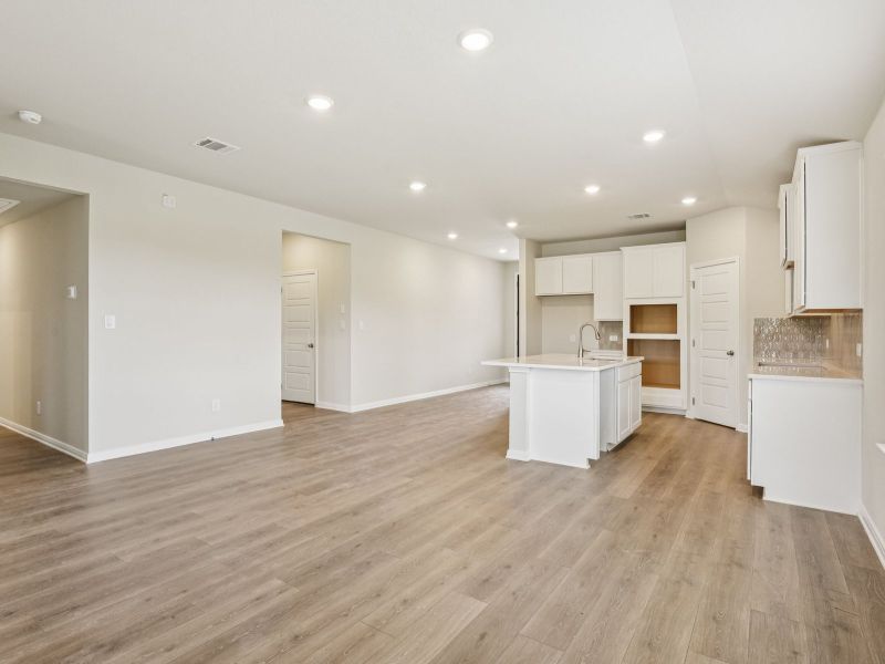 Dining room and kitchen in the Oleander floorplan at a Meritage Homes community.