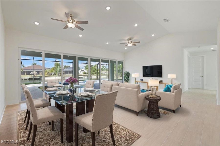 Dining room featuring recessed lighting, light wood-type flooring, a ceiling fan, and vaulted ceiling