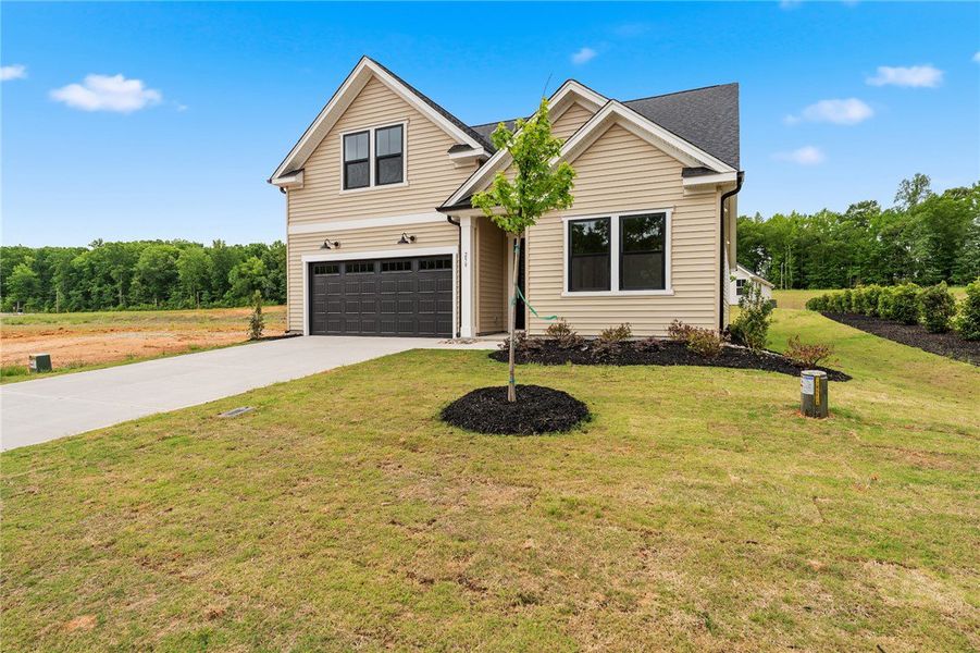 Front exterior of a new home in Saratoga Oaks, Williamston, SC, highlighting curb appeal (Image 2). Front exterior of a new home in Saratoga Oaks, Williamston, SC, highlighting curb appeal (Image 2).