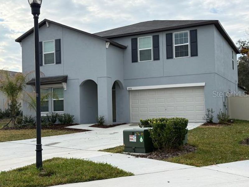 Front exterior of a new home in Berry Bay, Wimauma, FL, highlighting curb appeal (Image 1). Front exterior of a new home in Berry Bay, Wimauma, FL, highlighting curb appeal (Image 1).