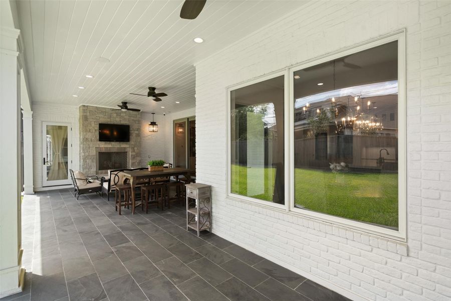 The large patio offers a perfect outdoor living space, with views of the fireplace and plenty of room for seating. It’s an ideal spot for entertaining, relaxing, or enjoying a cozy evening by the fire.