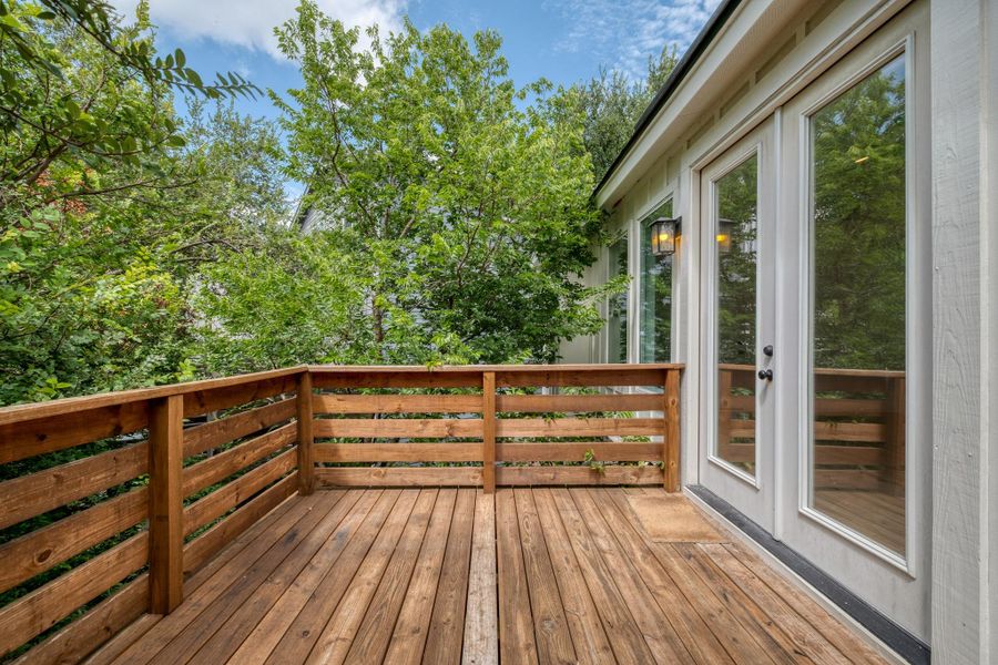 A spacious wood-planked deck with a sturdy railing overlooks a verdant landscape, offering an inviting outdoor retreat. A spacious wood-planked deck with a sturdy railing overlooks a verdant landscape, offering an inviting outdoor retreat.