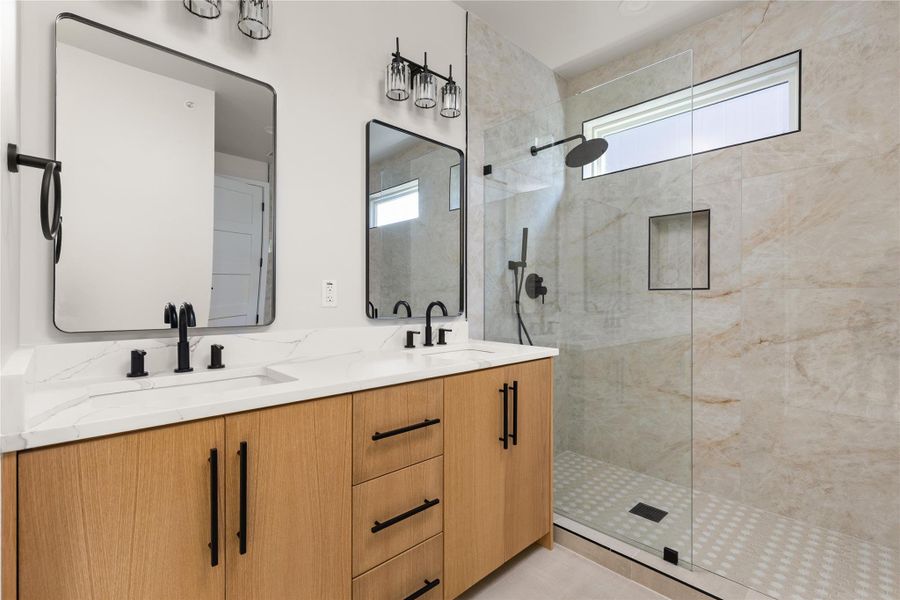 Clean lines and a spacious walk-in shower highlight this modern primary bathroom.
