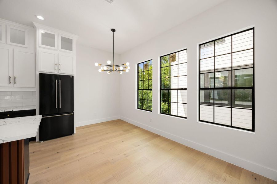A bright, inviting dining area offers the perfect space for a breakfast table or everyday dining, with abundant natuaral lghting and a seamless connection to the kitchen.
