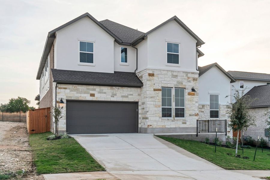 Front exterior of a new home in Capitol Collection at Lariat, Liberty Hill, TX, highlighting curb appeal (Image 28). Front exterior of a new home in Capitol Collection at Lariat, Liberty Hill, TX, highlighting curb appeal (Image 28).