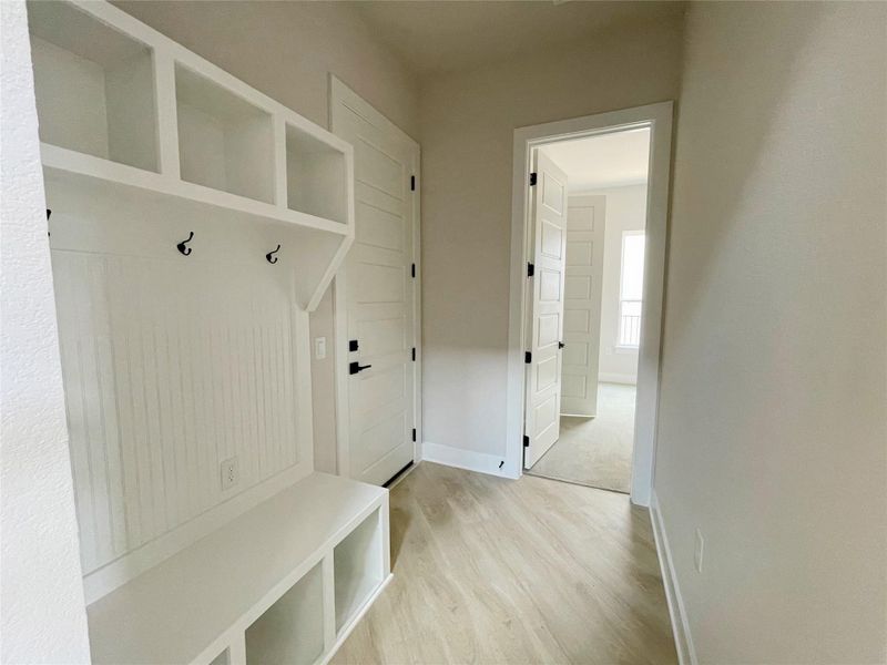 A convenient built-in mudroom bench with storage and coat hooks creates an organized entry. A convenient built-in mudroom bench with storage and coat hooks creates an organized entry.