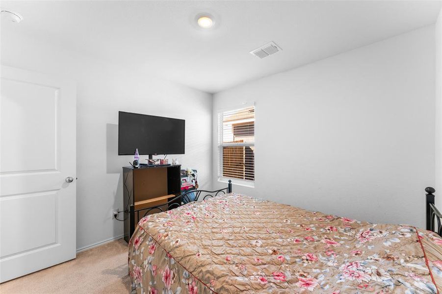 Bedroom with carpet floors and baseboards Bedroom with carpet floors and baseboards