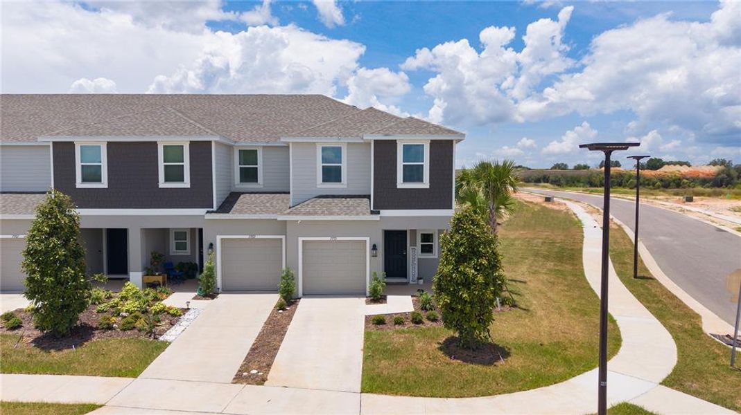 Front exterior of a new home in Waterstone, Groveland, FL, highlighting curb appeal (Image 21).