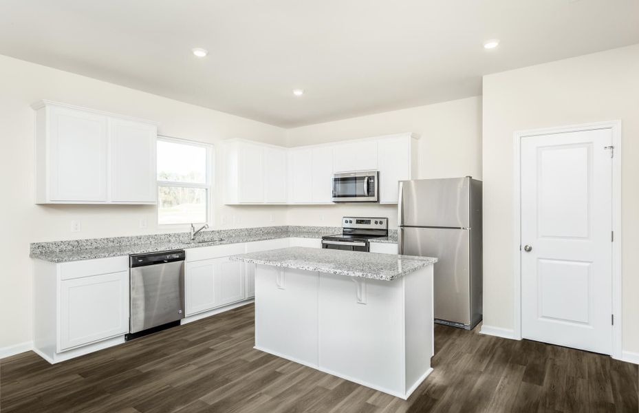 Package A Kitchen with beautiful white cabinets and granite countertops.