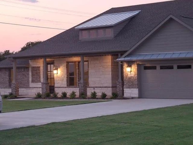 Front exterior of a new home in , Van Alstyne, TX, highlighting curb appeal (Image 27). Front exterior of a new home in , Van Alstyne, TX, highlighting curb appeal (Image 27).