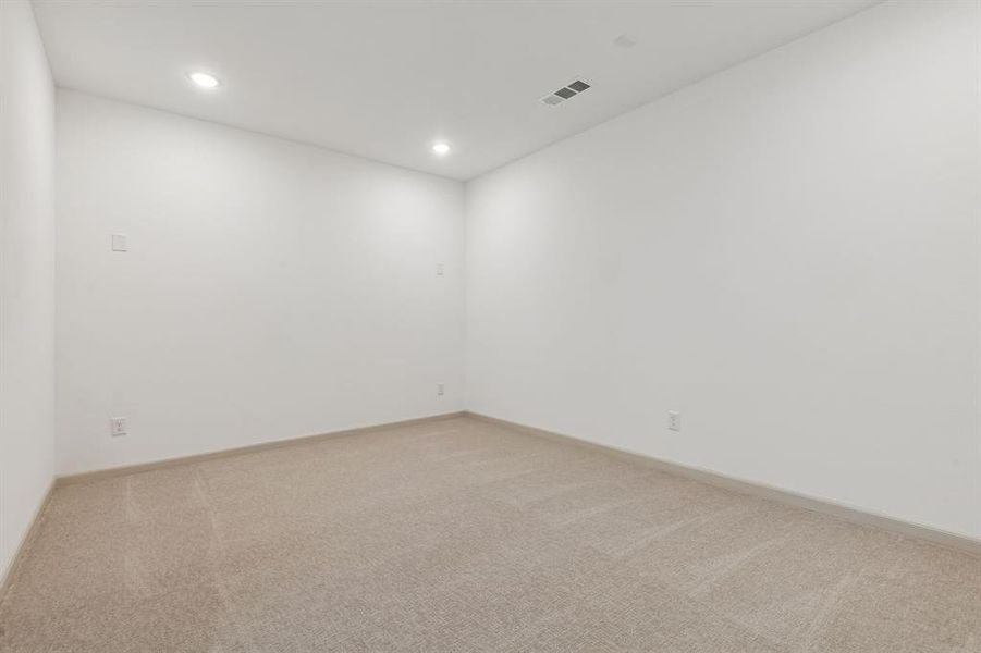 This spacious media room with adjoiningg game room create the ultimate family entertainment area in this dream home!