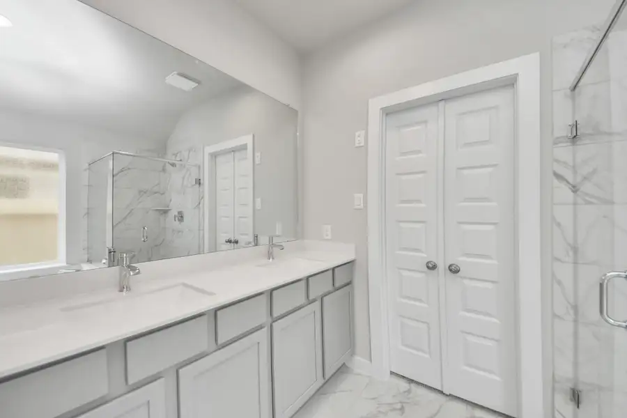 Elevate your daily routine at the elegant vanity, now equipped with double sinks, light countertops, modern hardware, and beautiful recessed lights. Sample photo of completed home with similar floor plan. Actual colors and selections may vary. Elevate your daily routine at the elegant vanity, now equipped with double sinks, light countertops, modern hardware, and beautiful recessed lights. Sample photo of completed home with similar floor plan. Actual colors and selections may vary.