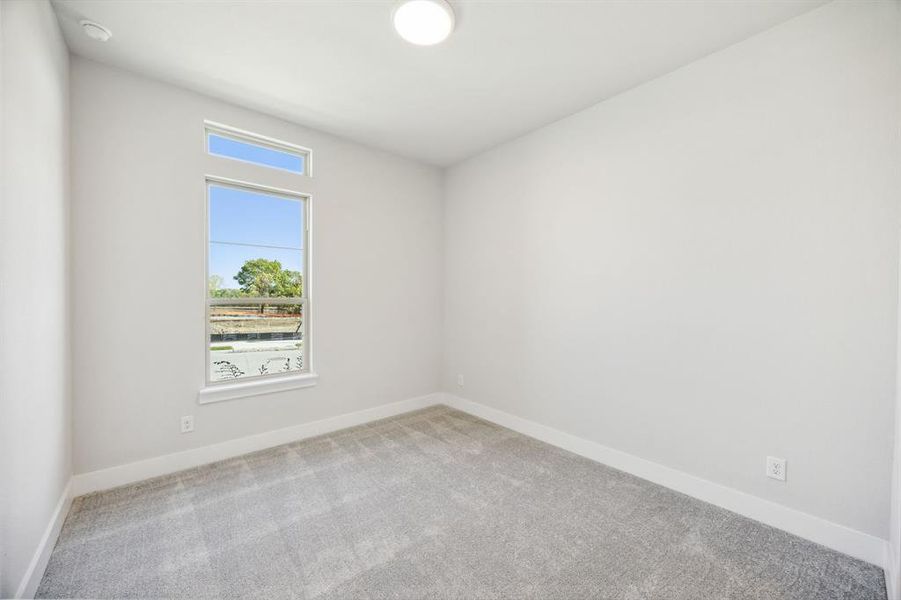 Unfurnished room with light colored carpet