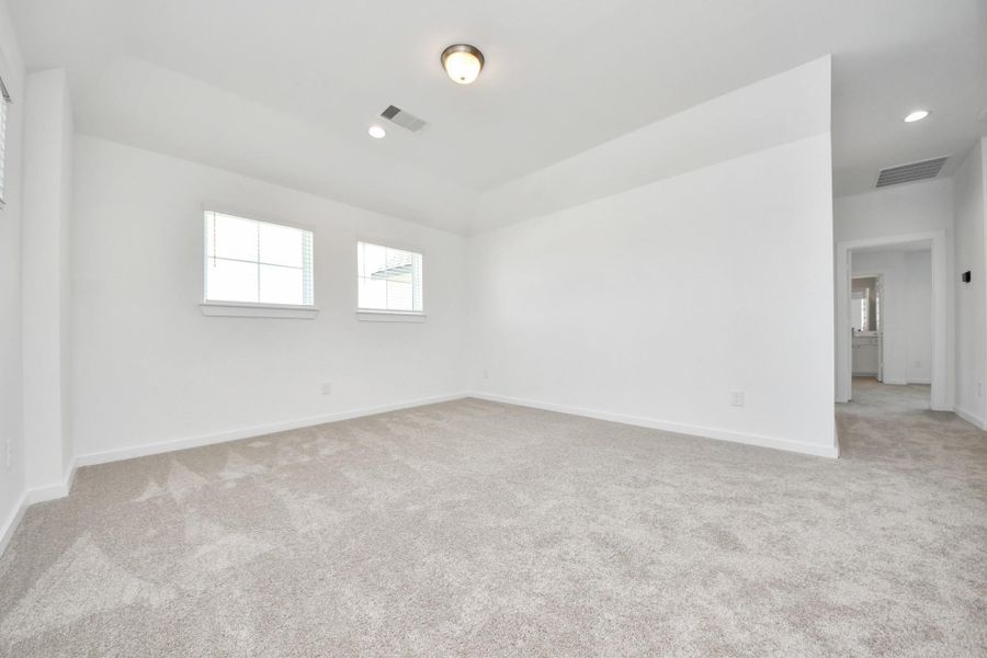 Discover a haven of leisure in this fantastic game room! Whether you're seeking a casual hangout or an adult gaming retreat, this space has it all. Enjoy the luxurious feel of plush carpet underfoot, the expansive ambiance of high ceilings, custom paint that adds a touch of personality, and windows that flood the room with refreshing natural light.