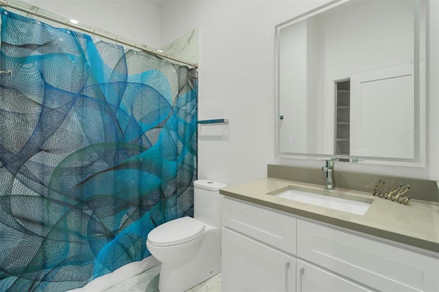 Full bathroom with curtained shower and vanity Full bathroom with curtained shower and vanity