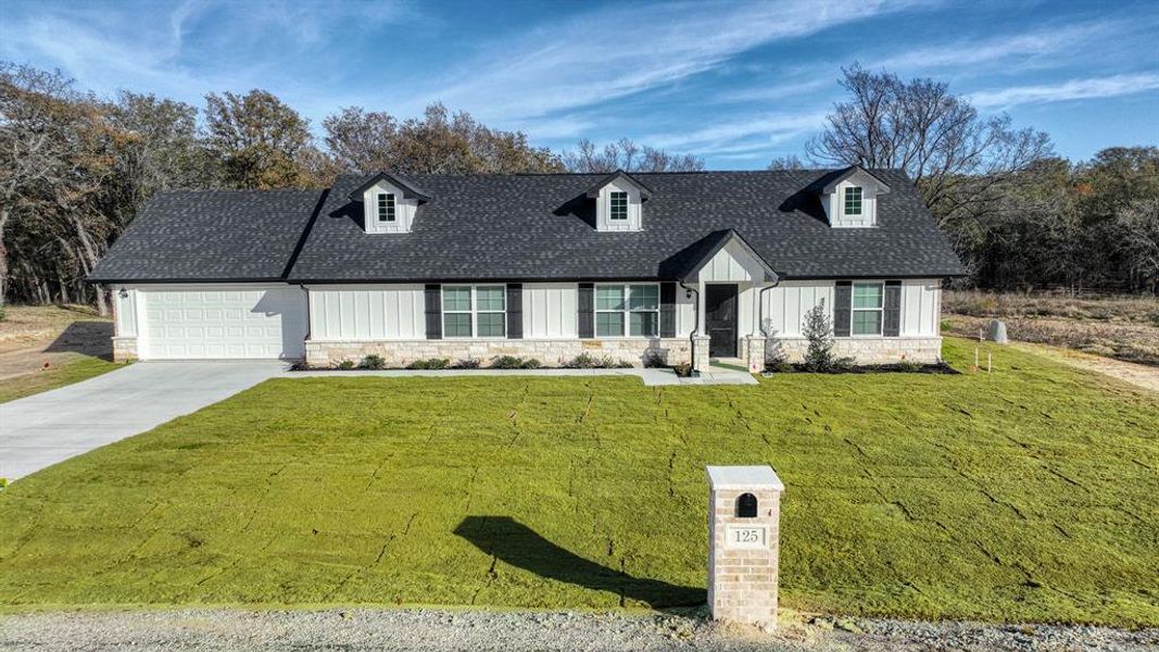 Front exterior of a new home in , Poolville, TX, highlighting curb appeal (Image 23).
