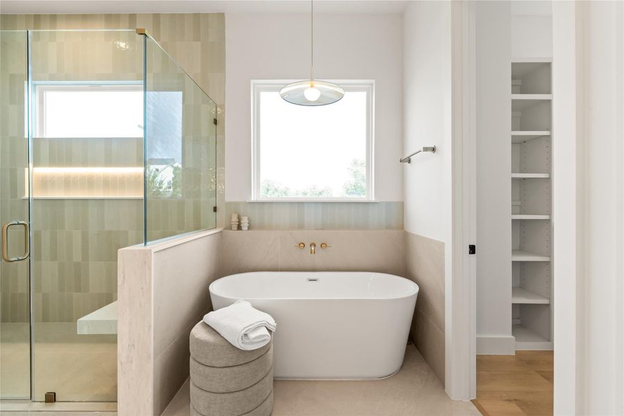 Tucked into its own quiet corner with a window for natural light, this freestanding tub feels like a real invitation to unwind, not just a box to check. It's the kind of feature buyers picture themselves using on day one.